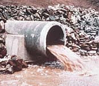 Photo illustrating how an end-of-pipe effluent release may contribute to chemical loads in surface waters.