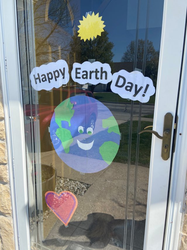 a glass door with Happy Earth Day drawings