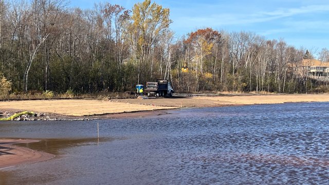 Erosion control straw matting is placed on the shoreline of the Shallow Sheltered Bay to protect the soil and seeded areas. 