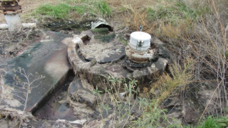 Sewage and rags around the Peridot Lift Station manhole.  Culvert that transfers the wastewater into the wash downgradient of the lift station. 