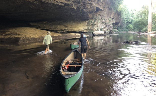 Crew members wade through stream on their way to sample for the NRSA 2018-19 survey