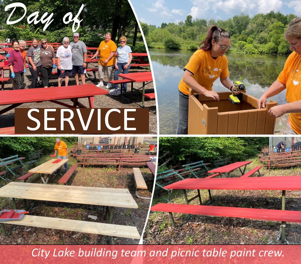 people painting the picnic tables red