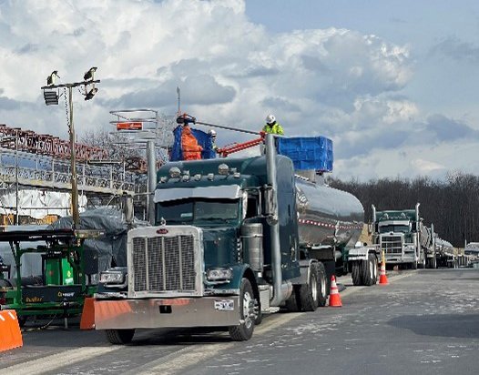 Trucks are loaded with non-hazardous water for off-site disposal
