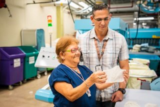 Image of a woman holding a bandage with man looking on.