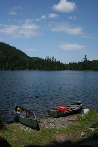 Two canoes on edge of Denny Pond. Hilary Snook.