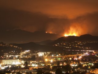 Evening photo of active fire near buildings in Los Angeles