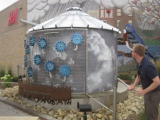 a large metal cistern holding tank that collects water from a large commercial building