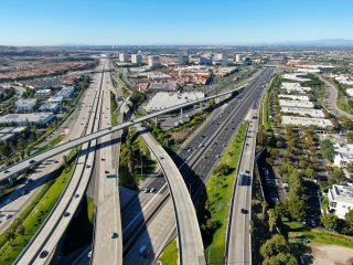 Aerial view of highway transportation with small traffic, highway interchange and junction, San Diego Freeway and Santa Ana Freeway.